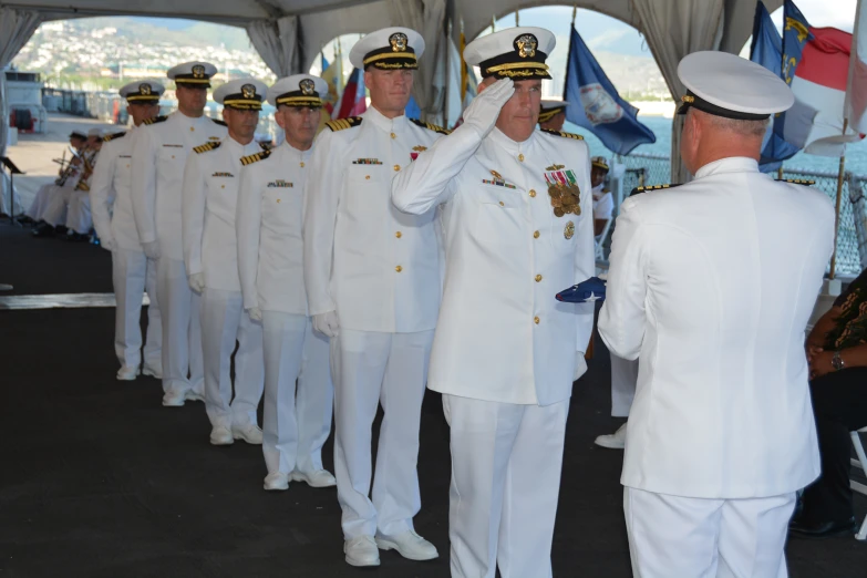 a group of sailors saluting at the crowd