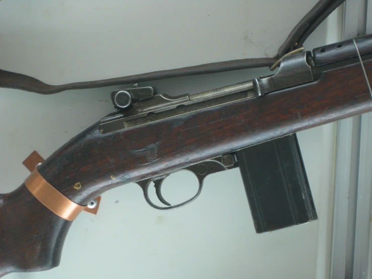 a rifle mounted on a wall next to a magazine