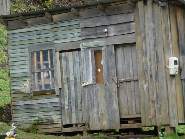 a log house with wooden sidings and a wooden door and windows