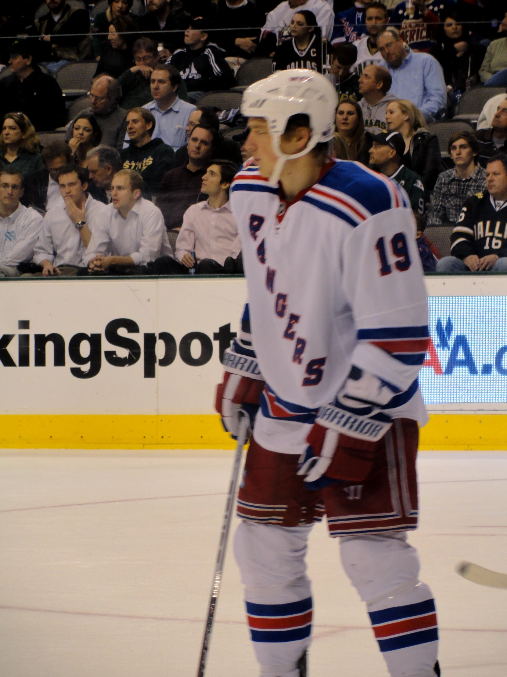 hockey player wearing uniform and helmet looking into the crowd