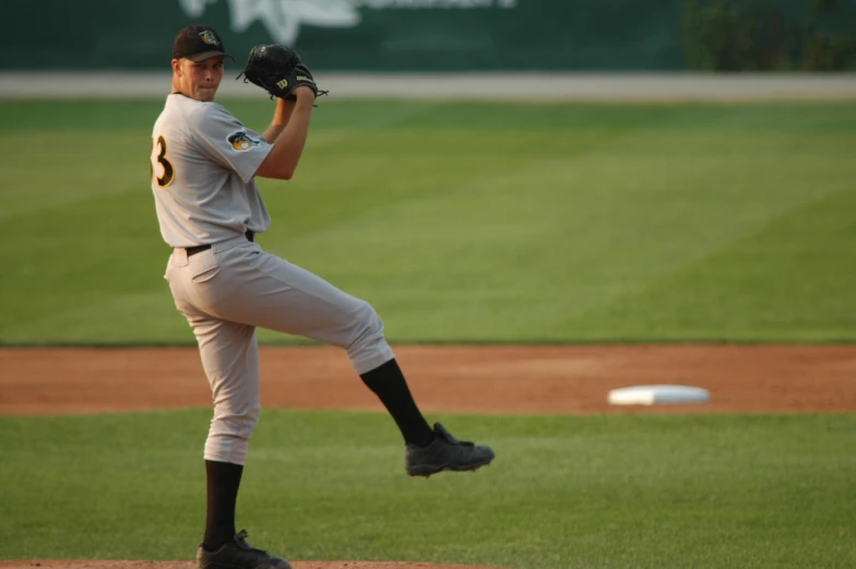 a baseball player wearing a uniform catching a ball