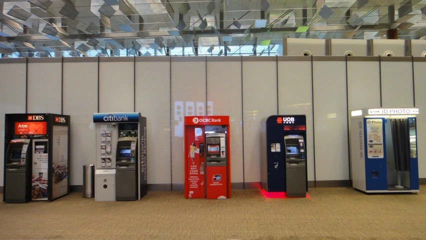 four machines on display with price signs, one red and one blue