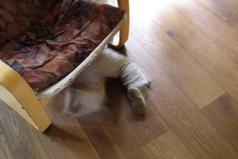 blurry po of the child crawling through a chair