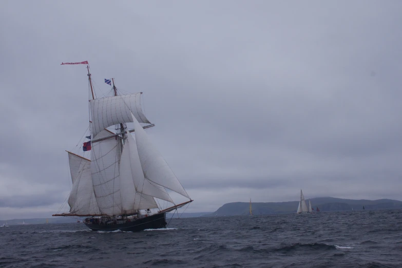 a large sailboat is sailing on the ocean