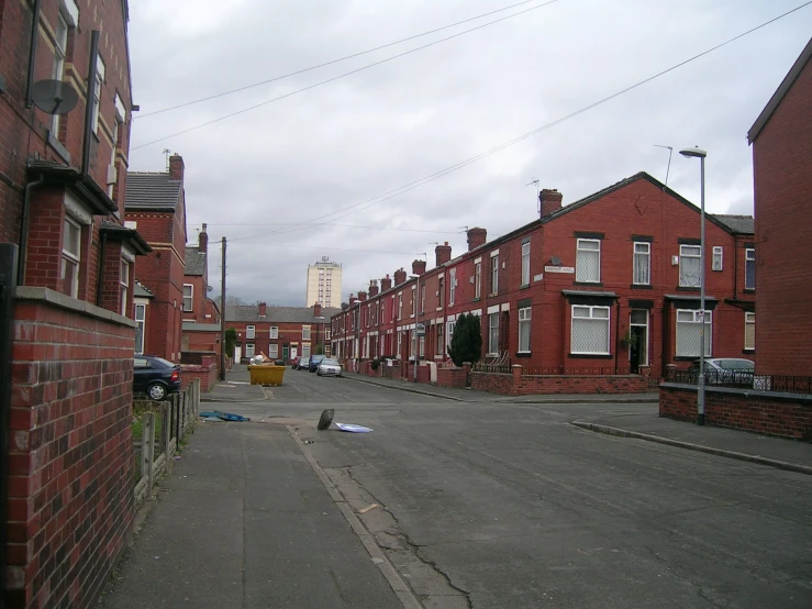 a narrow empty street lined with small brick buildings