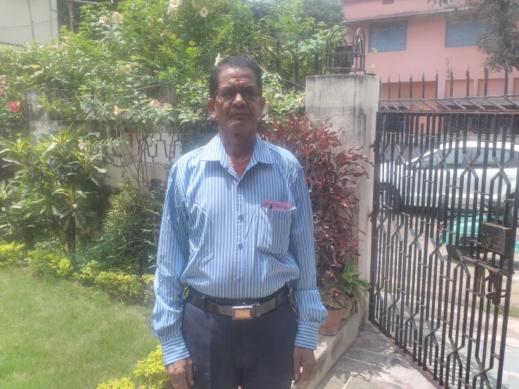 a man standing by the fence with his eyes closed