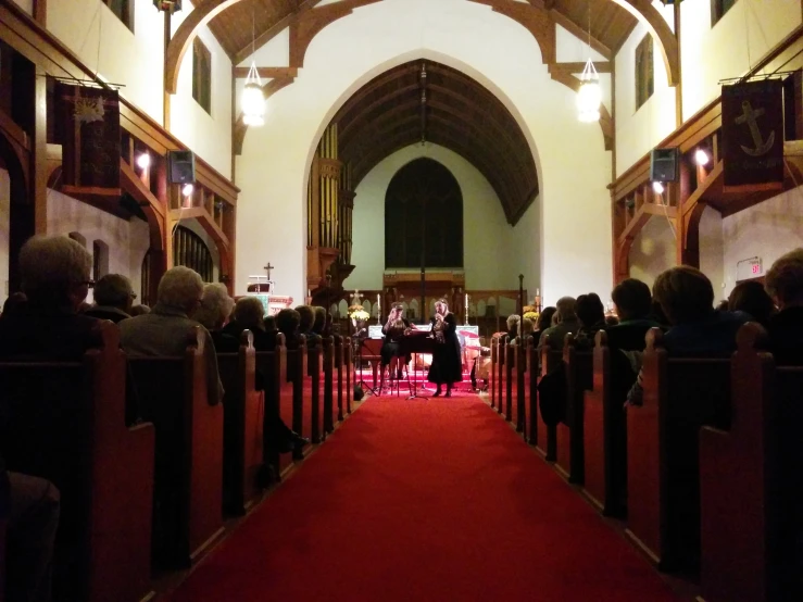 a group of people in chairs standing at a church