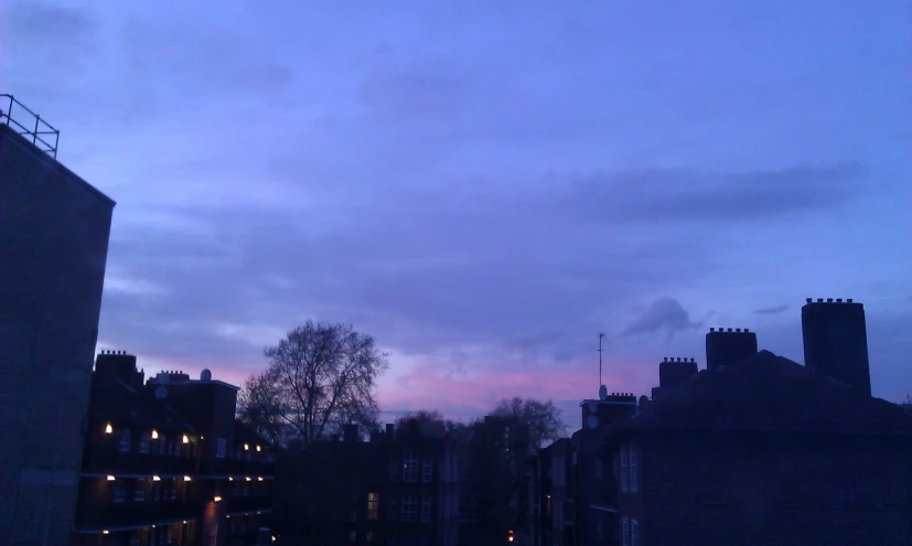 twilight skies can be seen through the rooftops