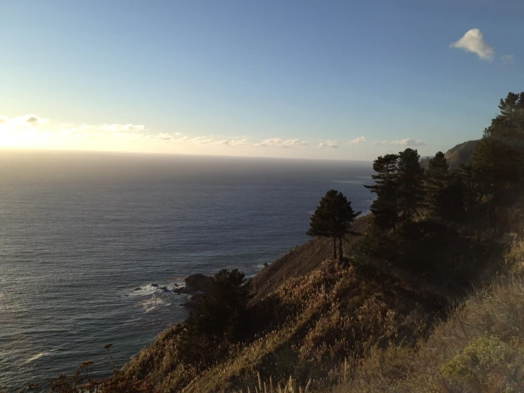 a mountain overlooking the ocean with an elephant on the side