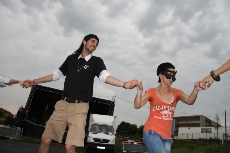 a couple of people holding hands on top of a street