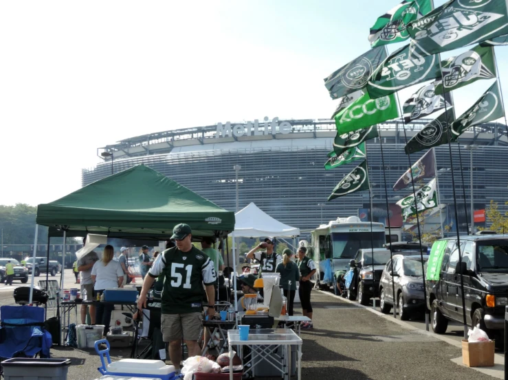 the fans are standing next to trucks on the side walk