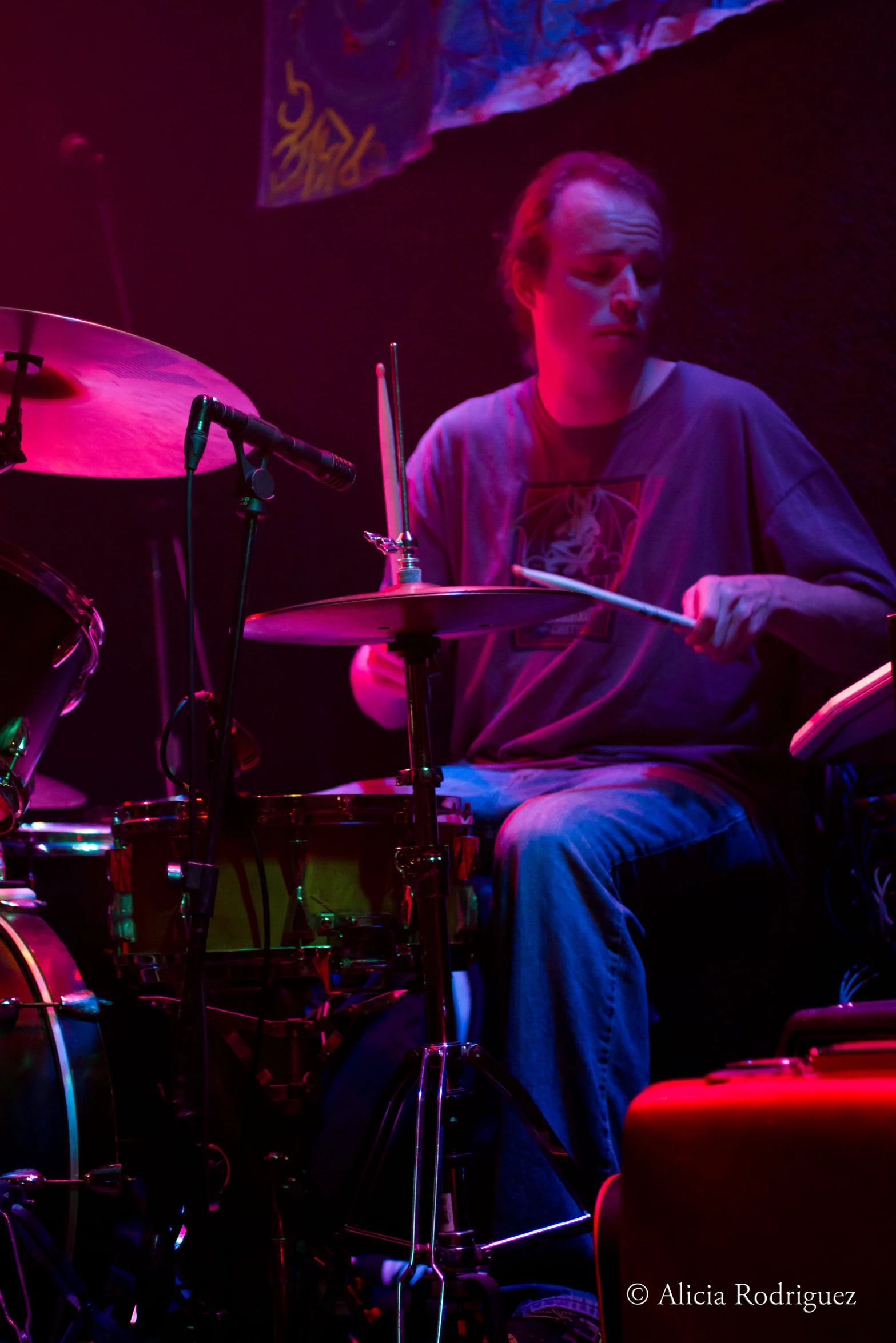 a person in a room playing drums and sitting