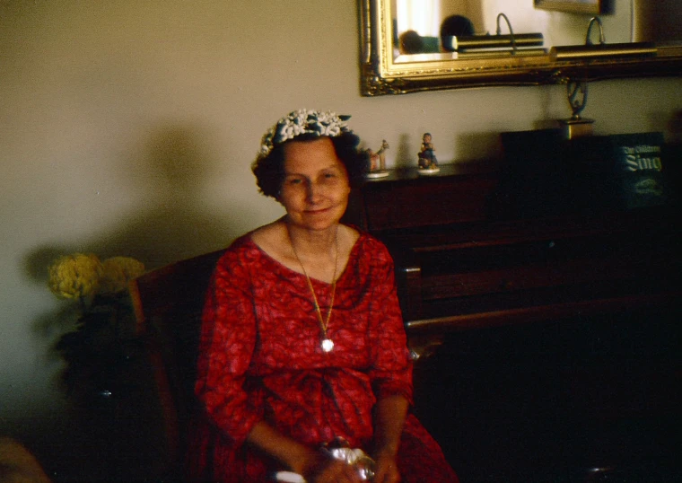 an old woman in a red dress holding a game controller