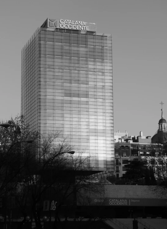 a black and white po of a building near a train