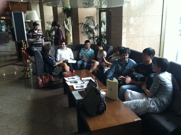 a group of people in an airport waiting for luggage