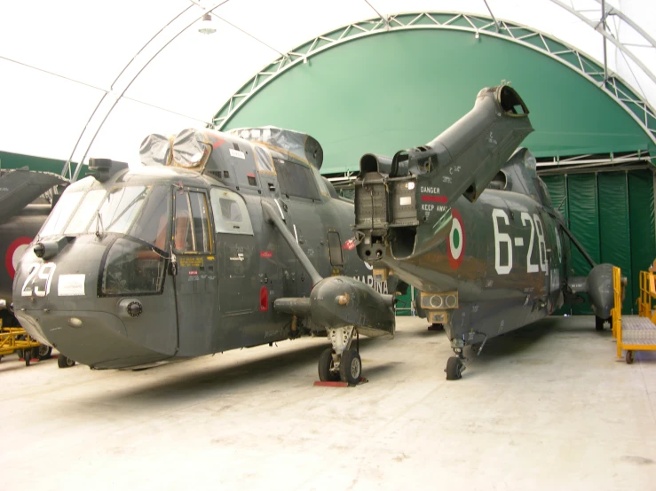 large helicopter type sitting inside of an airport hangar