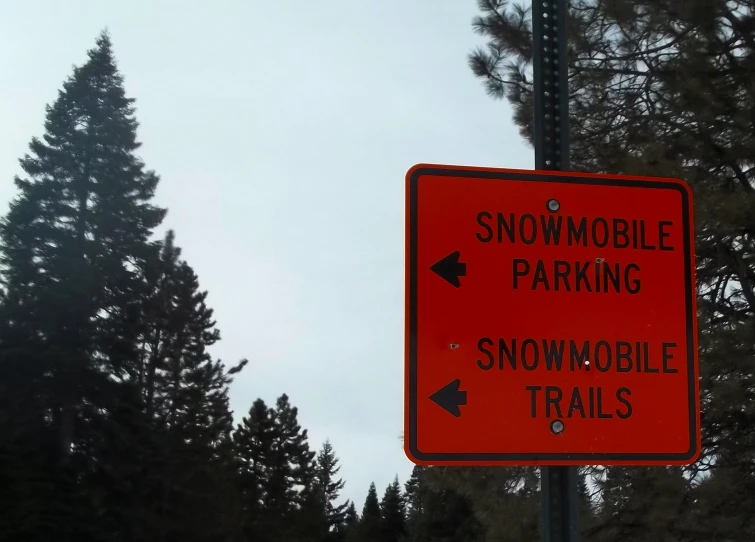 an red sign is shown next to trees