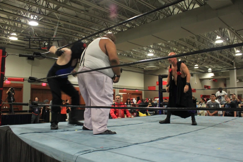 wrestlers are standing around in the middle of the ring