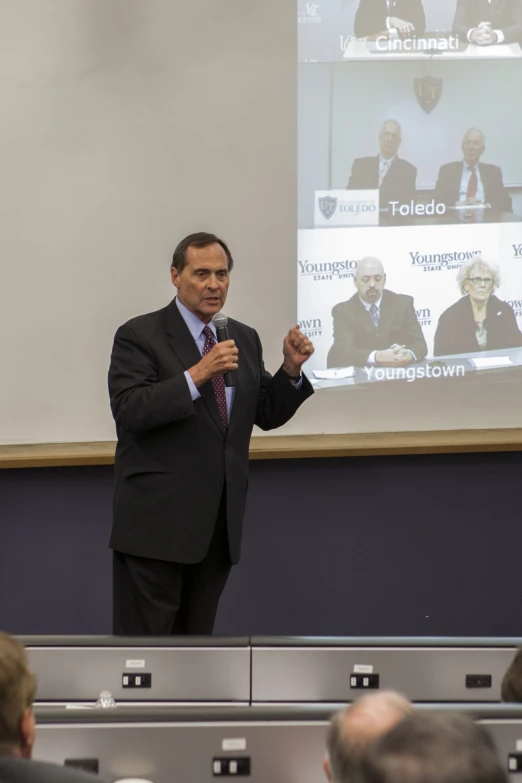 a man giving a speech in front of a class