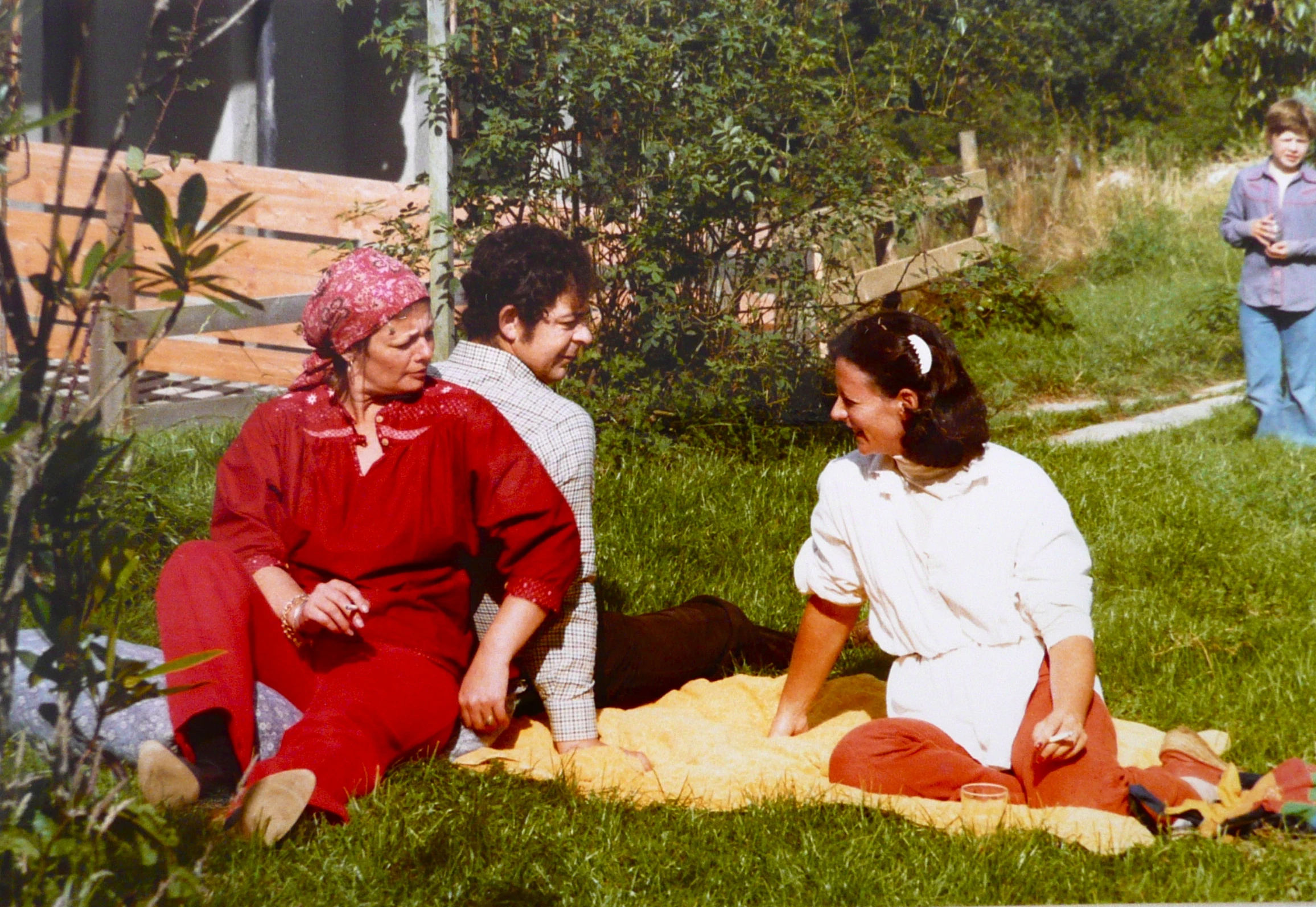 a po shows two women laughing together in the grass