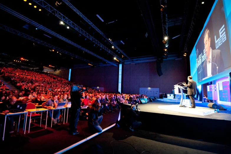 the audience at an event is watching the man on stage