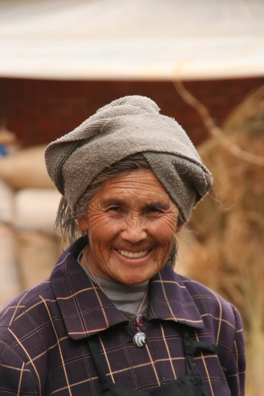 an old woman smiling in the middle of nowhere