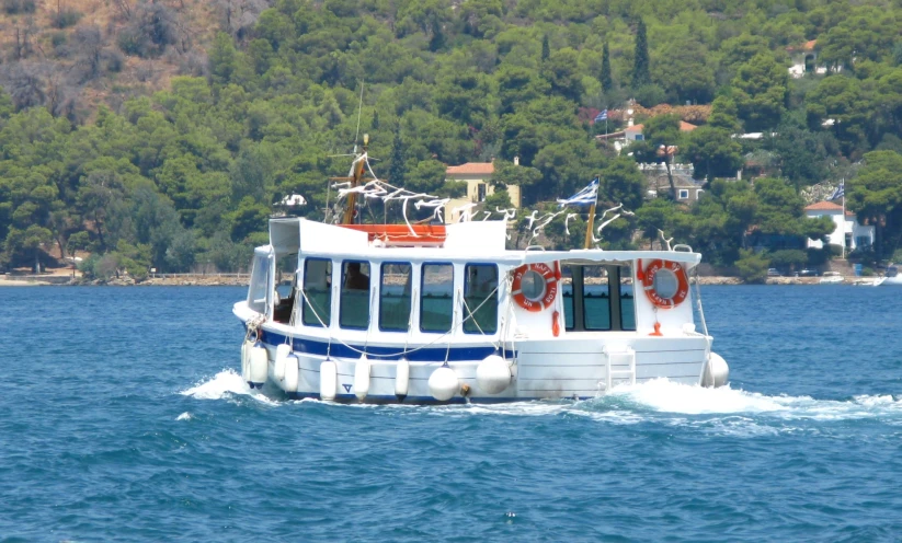 a small ferry boat is traveling on the water
