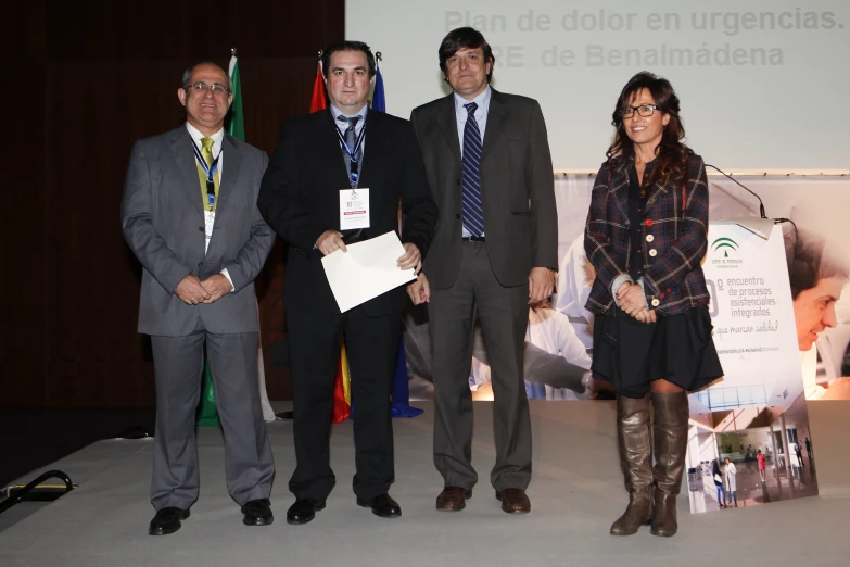 four people are standing together in front of a presentation