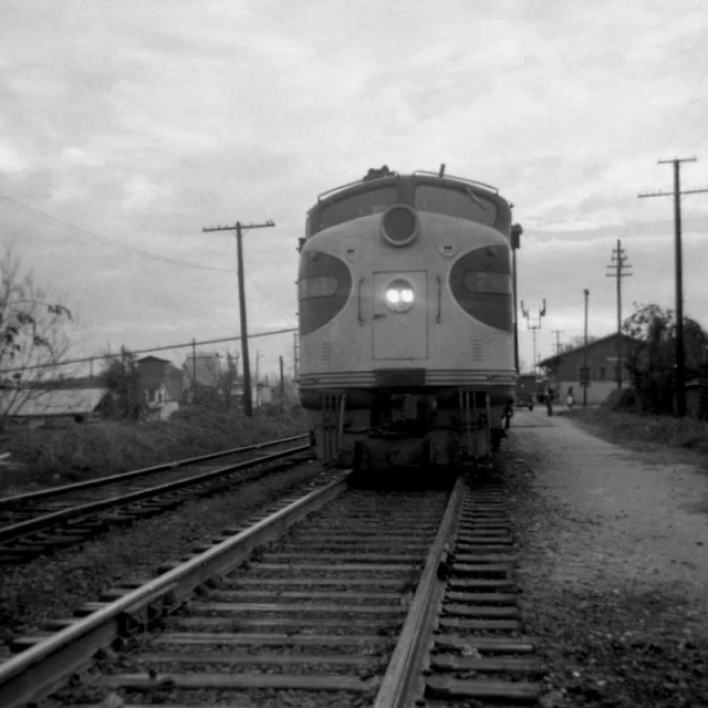 an old train engine is on the railroad tracks