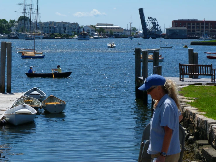 a lady standing on the side of a dock