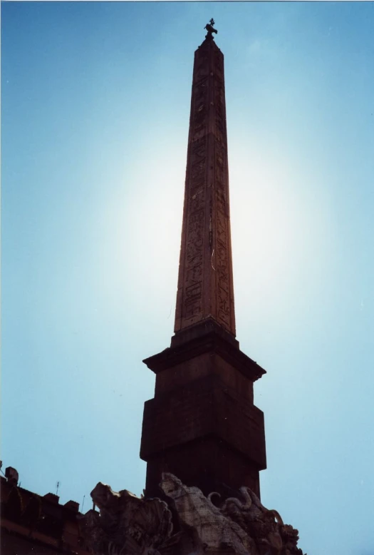 a monument that is next to some clouds