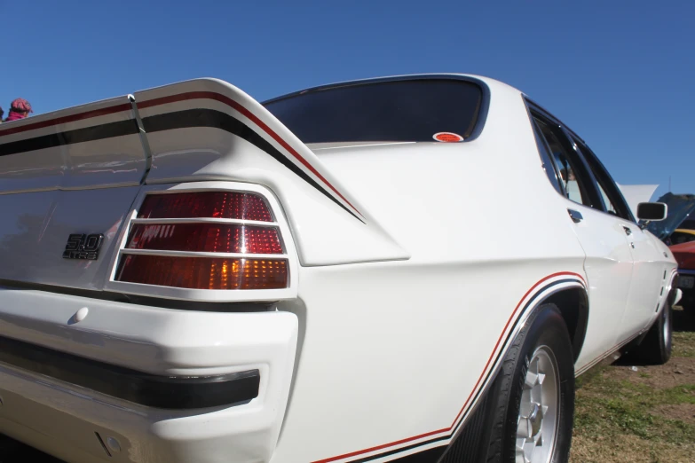 a back view of a car parked in grass