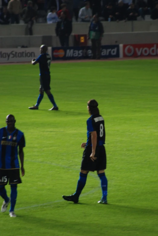 the men are playing soccer on the field