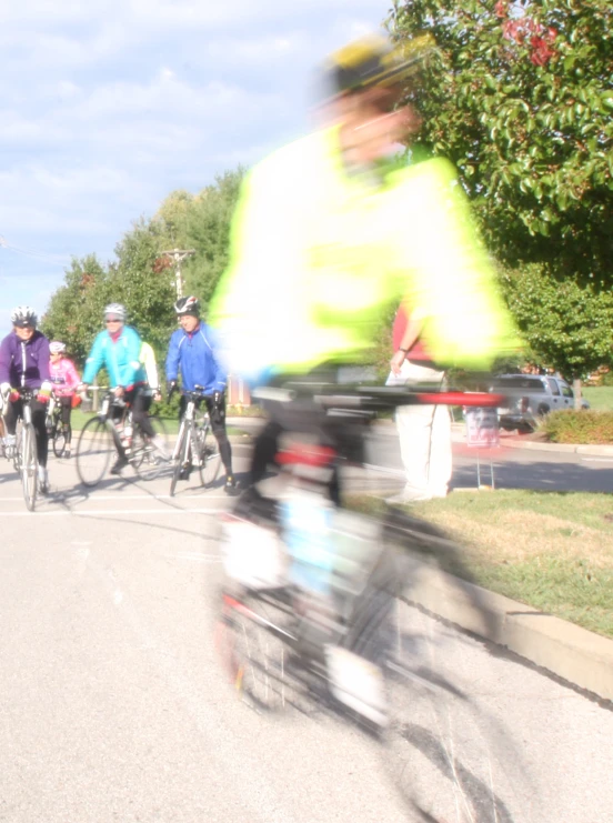 a bunch of people riding bikes down the street