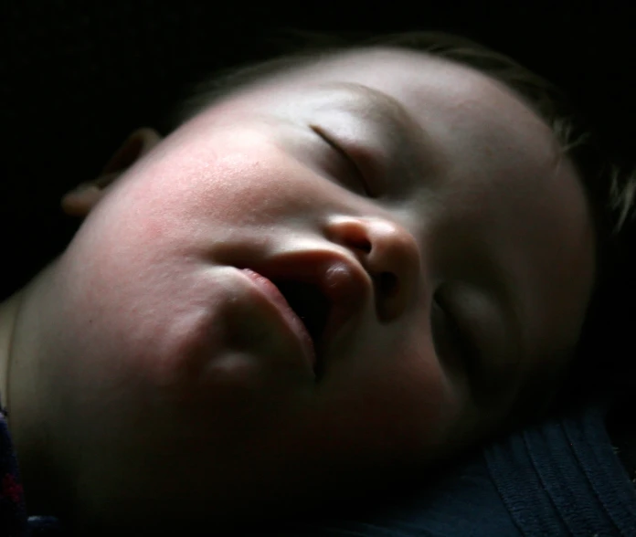 a baby is asleep with his eyes closed