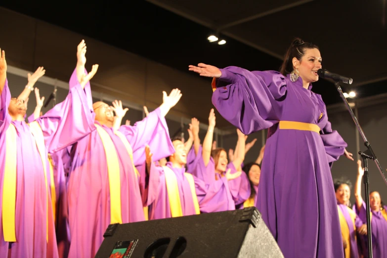 there is a woman singing in front of choir