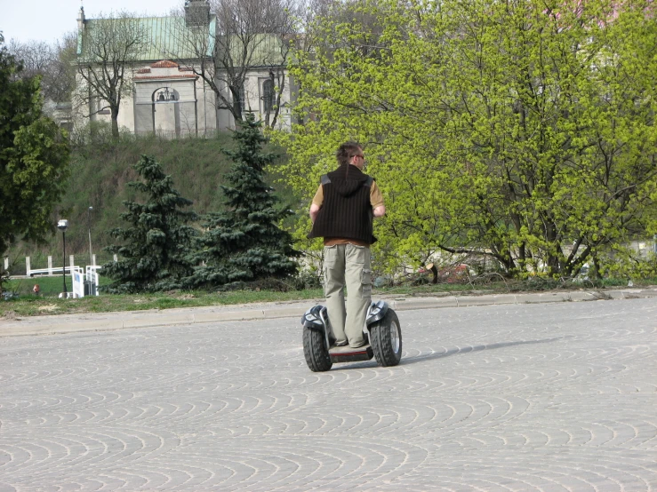 a person on a segway and some trees