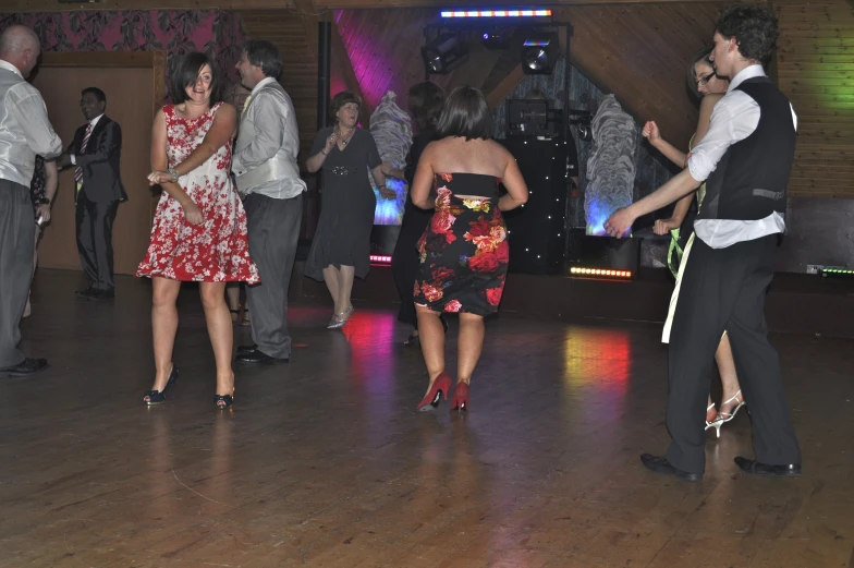 people standing around in the middle of a dance floor