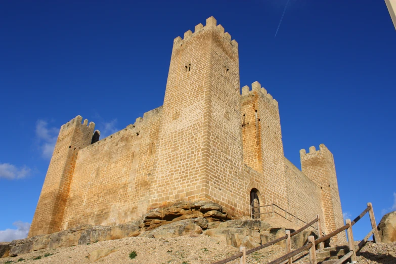 the stone tower on the building has steps to it