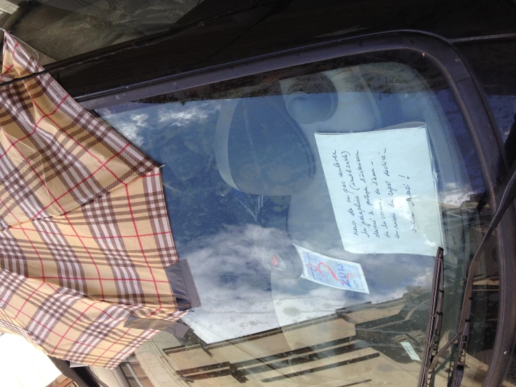 an umbrella is hanging from a vehicle window