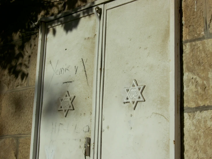 a door in front of a building with graffiti