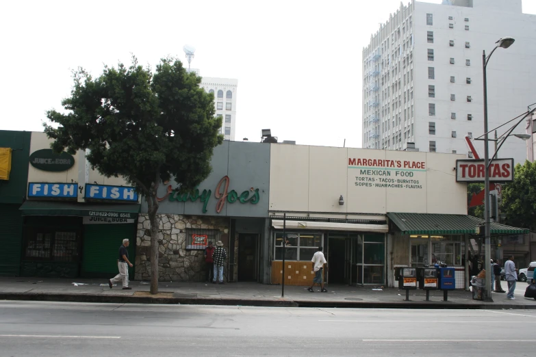 an empty street in a city with shops on each side