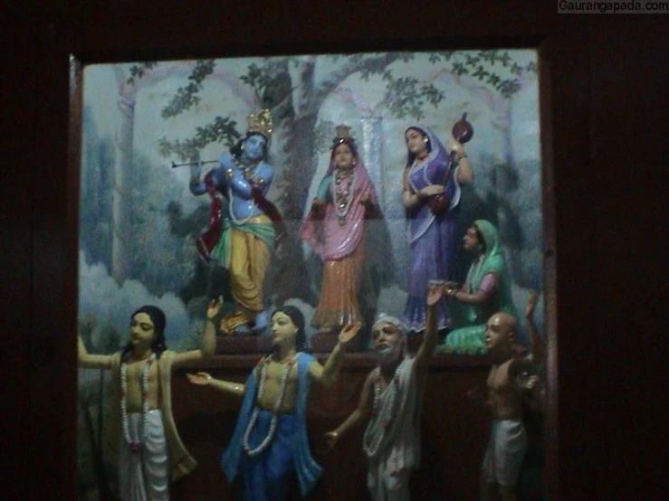 framed oil painting of hindu worship with man and woman