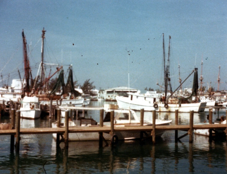 some large boats are moored next to a dock