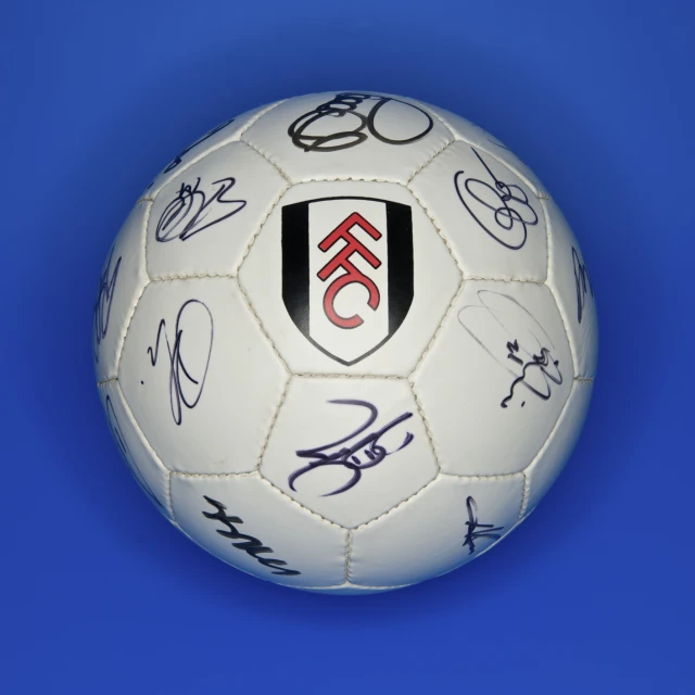 a soccer ball is filled with many autographs