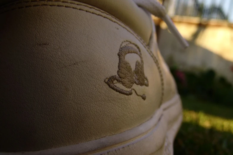 a closeup view of someone's shoe with a logo painted on it