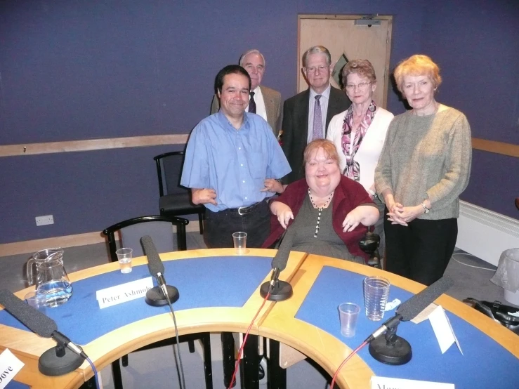 a group of people standing together in a radio room