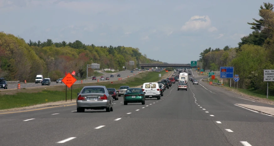 an empty highway with cars and truck on one side