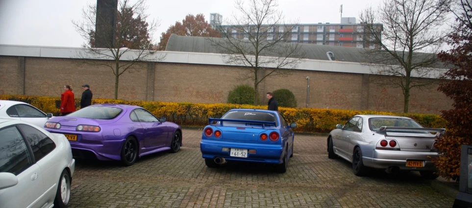 cars parked in a lot with a person in the background