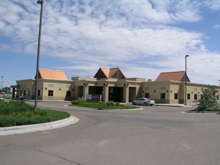 a parking lot with several cars parked in front of it